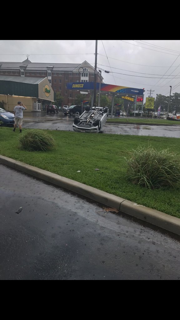 A car is upside down in the street, still with its lights and wipers on. Photograph Courtesy City of Salisbury