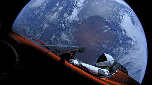 "Starman" cruises through Space with the Earth in the background. Image: SpaceX