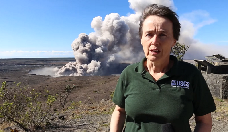 Tina Neal stands near the USGS Hawaii Volcanoes Observatory as ash rises from the Kilauea caldera behind her.  Image: USGS