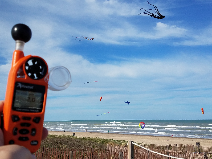 With spring breakers gone, meteorologists head to South Padre Island in April for the annual National Tropical Weather Conference. This picture, snapped in 2017, shows a Kestrel pocket anemometer spinning as kites fly outside of the hurricane conference. Image: Weatherboy