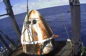 The Crew Dragon is recovered onto a ship shortly after a successful splash-down in the Atlantic. Image: NASA