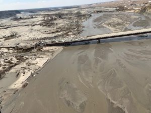 Aerial view shows a dam wiped out, along with nearby highway infrastructure. Image: Nebraska Governor Pete Ricketts / Twitter