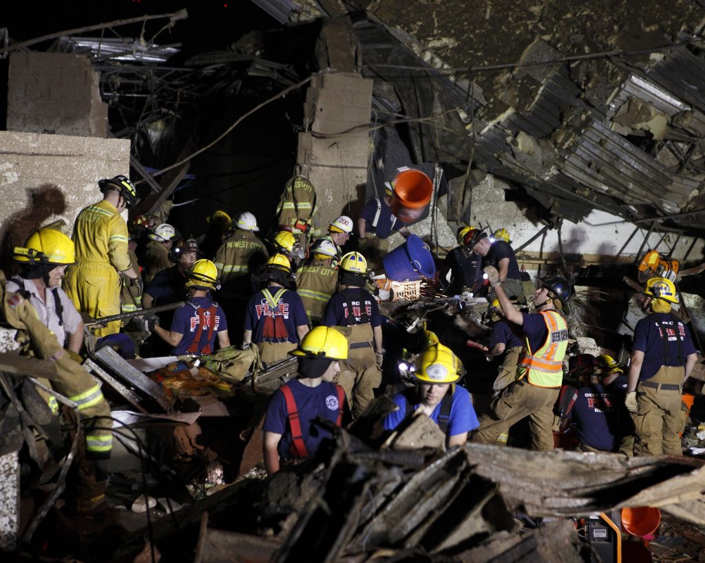 Over a dozen emergency workers comb through the rubble of Plaza Towers Elementary School after a tornado leveled it on May 20, 2013. Image: Oklahoma National Guard