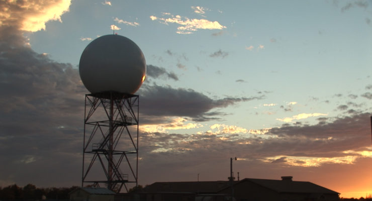 A NOAA Radar Unit stands before a setting sun. Image: NOAA