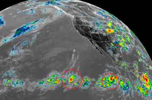 Tropical cyclones could form within these clusters of clouds, showers, and storms in the Pacific Ocean in the coming days. Image: NOAA