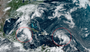 Two tropical cyclones are circled on the latest GOES-East weather satellite view; on the left is Tropical Depression #14 which is forecast to become Hurricane Marco; on the right is Tropical Storm Laura which is also forecast to become a hurricane. Both are forecast to eventually reach the Gulf of Mexico and impact the United States. Image: NOAA