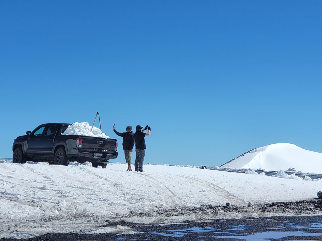 A common scene on Mauna Kea: locals load-up the back of their pick-up trucks with snow and bring it down to the lower elevations for others to enjoy it. Snowmen can even be spotted on the beaches, albeit briefly, on the Big Island. Image: Weatherboy