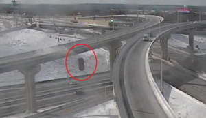 A traffic camera captured the moment a pickup truck plunged over the side of an icy highway overpass. Image: Wisconsin DOT
