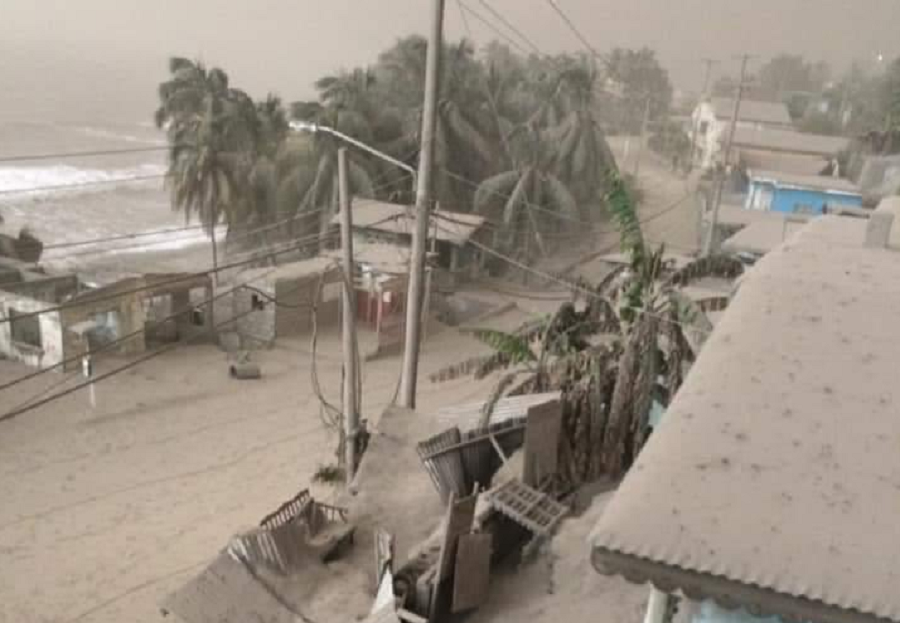 Ash continues to fall on St. Vincent, home of the La Soufriere Volcano that continues to erupt. The waterfront here is covered in thick ash, with the weight of the ash collapsing some structures. Image: Caribbean Disaster Emergency Agency
