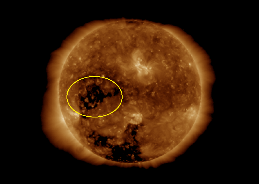 Imagery from the GOES-16 weather satellite today captures a coronal hole on the Sun; it is the dark region within the yellow circle. Image: NOAA / SWPC