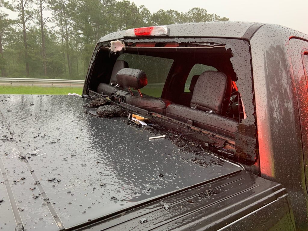 After striking the occupants, the debris left the rear of the truck, destroying the rear window in the process.  Image: Walton County Fire Rescue