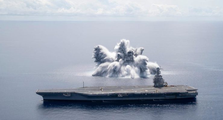 Water erupts into the air from an explosion alongside the USS Gerald Ford (CVN 78). Image: US Navy
