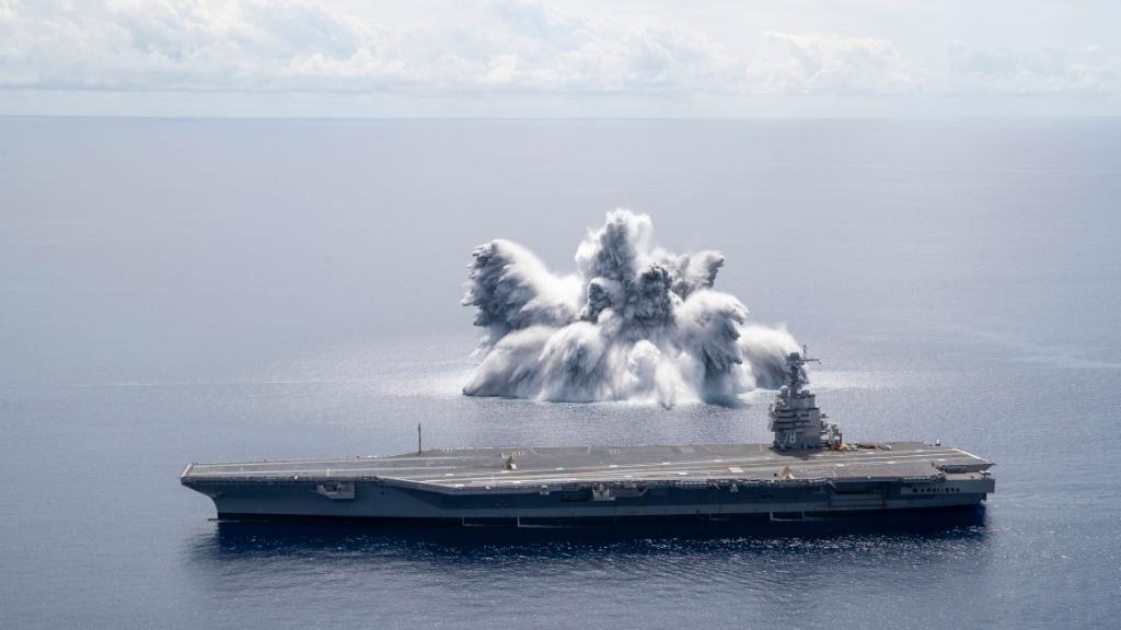 Water erupts into the air from an explosion alongside the USS Gerald Ford (CVN 78). Image: US Navy