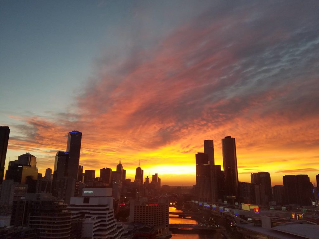 The sun rises over the skyline in Melbourne, Australia. Image: Weatherboy