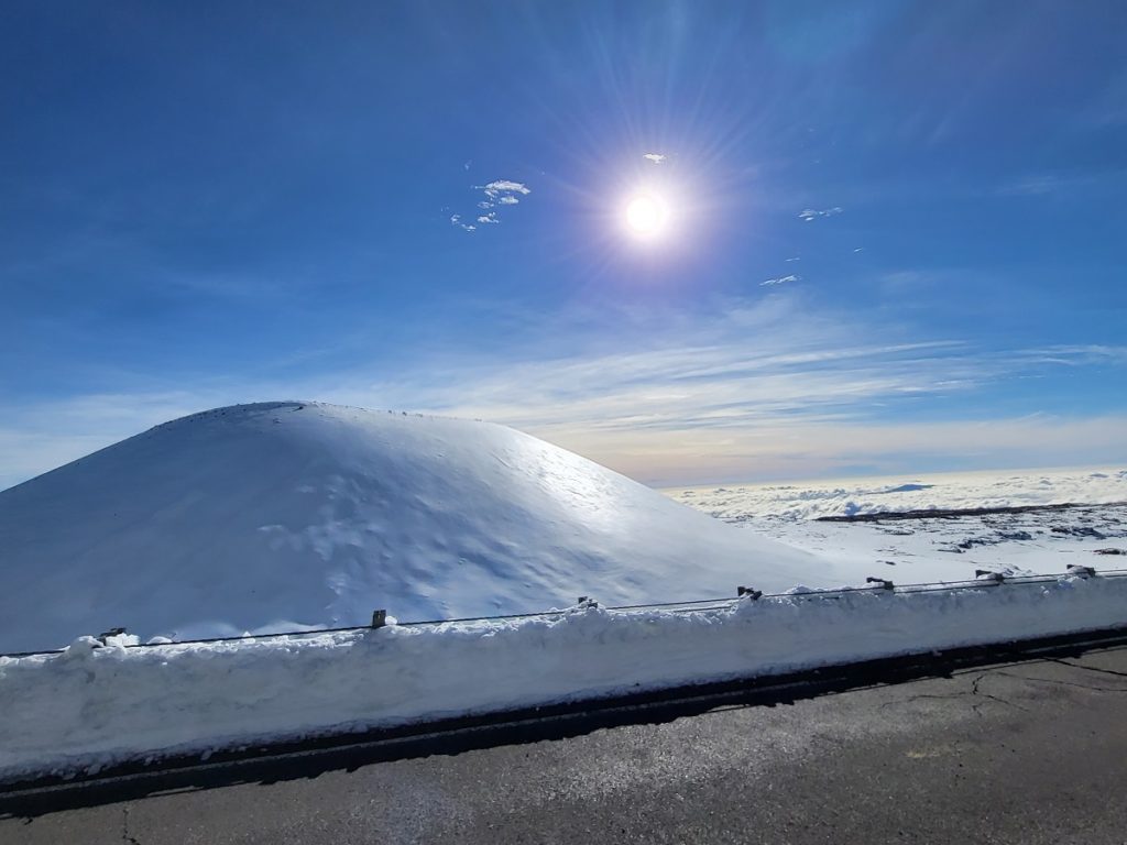 The snow plows cleared the roads nicely, blowing deep snow and drifts off of the pavement here at Mauna Kea where roads finally opened today after the weekend blizzard in Hawaii. Image: Weatherboy