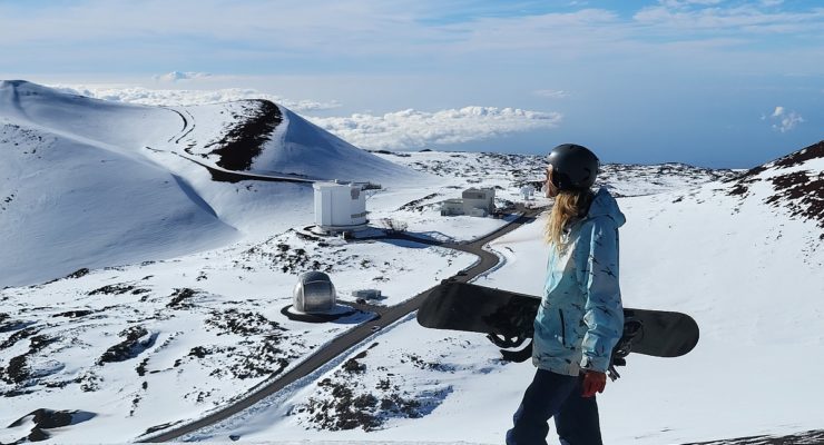 A snowboarder looks at the slopes of Mauna Kea before gliding down its fresh December snowfall. Image: Weatherboy