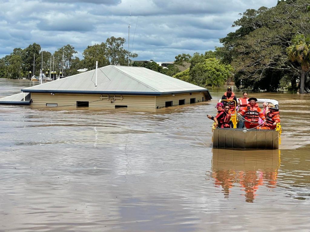Rescue crews pick-up flood survivors as flood waters rise and overwhelm communities from the "Rain Bomb." Image: Queensland Fire & Emergency Services