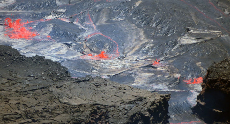This image shows spattering on the active lake surface of Halema‘uma‘u, as seen during a Kīlauea summit observational field shift on June 29, 2022 on the Big Island of Hawaii. This is one of four volcanoes at an ORANGE / WATCH level in the United States. Image: USGS / L. Gallant
