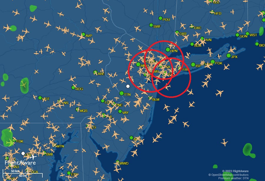 This is the current air travel map produced by FlightAware, reflecting the location of every airplane in the region.  Newark Liberty, La Guardia, and John F. Kennedy Airports are circled in red.  Image: FlightAware