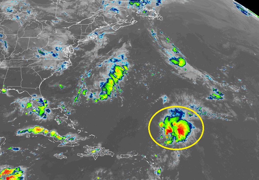The yellow circled cluster of showers, storms, and clouds are being being monitored by the National Hurricane Center. Image: NHC