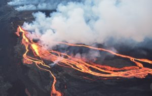 Lava flows down the slopes of Mauna Loa Volcano to the area known as the "saddle" between Mauna Loa volcano to the south and Mauna Kea volcano to the north. Image: USGS / Civil Air Patrol