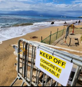 A large portion of the Kaanapali Beach Resort walkway has collapsed into the surf, with ocean waves eating away at the sand from what was once a beach filled with sunbathing tourists. Image: Weatherboy
