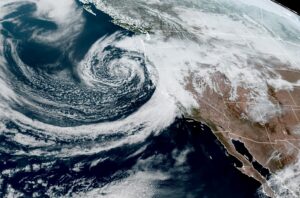 The latest GOES-West weather satellite view shows the center of low pressure moving into the California coast today. Image: NOAA