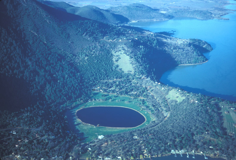 Little Borax Lake, along the western shore of Clear Lake , formed after an eruption occurred though a landslide deposit on the southeastern shore of the lake.  The lake is now in the center of Buckingham Golf Course on the northern slope of Mount Konocti contained within the broader Clear Lake Volcanic Field, which is monitored by USGS and CalVO.  Image: Julie M. Donnelly-Nolan / USGS