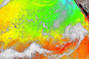 A colorized photograph snapped by the GOES-West weather satellite shows water temperatures, with warm, tropical-cyclone friendly waters showing in red and orange and colder waters that weaken tropical cyclones in blues and greens.  Image: NOAA
