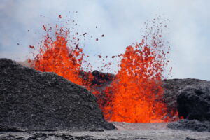 This telephoto view shows one of the erupting vents in Kīlauea caldera during the September 2023 eruption. Lava fountain heights at the vents reached up to about 32-50 feet and the horseshoe-shaped spatter ramparts that have accumulated on the south/downwind side of the vents remain 66 feet high. Another eruption at the volcano could produce similar results soon. Image: USGS / M. Patrick