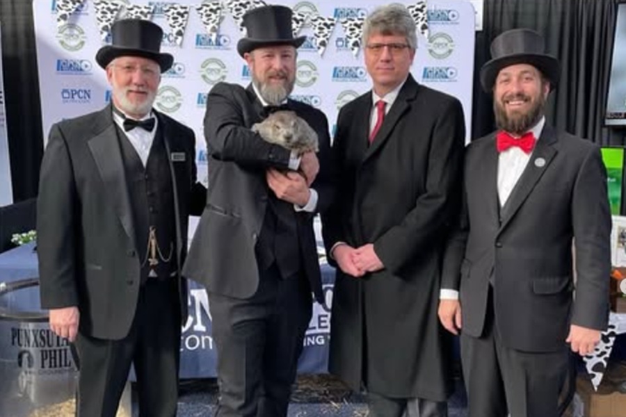 Punxsutawney Phil poses with his handlers ahead of the 2025 Groundhog Day festivities in Pennsylvania.  Image: Punxsutawney Groundhog Club / Instagram