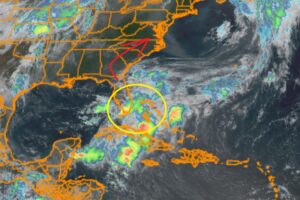 Current GOES-East satellite with the disturbance being tracked by the National Hurricane Center circled in yellow. It is expected to travel in the direction of the red arrow this week. Image: NHC