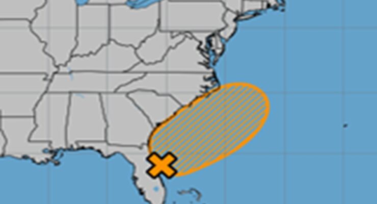 The National Hurricane Center says it is now more likely than not that a system will form near the X and move around in the orange shaded area on this map over the holiday weekend. Image: NHC