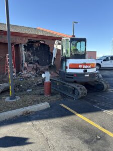 Crews work around the part of the National Weather Service building which was damaged when it was struck by  a car this weekend.  Image: NWS